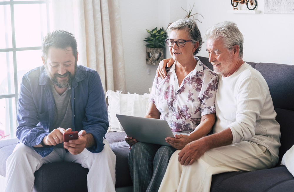 caucasian-family-home-using-modern-technology-device-as-phone-laptop-computer-together-having-fun-people-alternative-work-style-office-leisure-online-activity